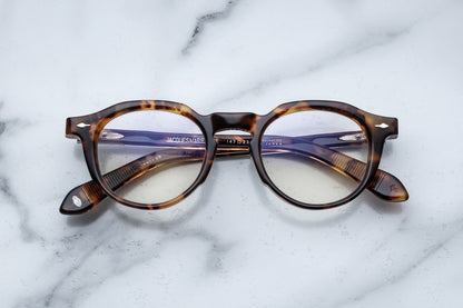 Overhead view of tortoise patterned round eyeglasses with silver accents