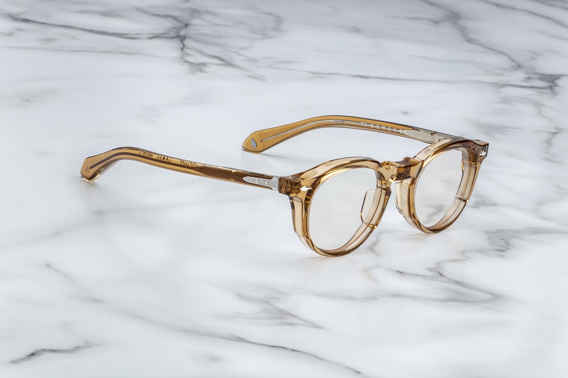 Side view of light brown translucent round eyeglasses with silver accents