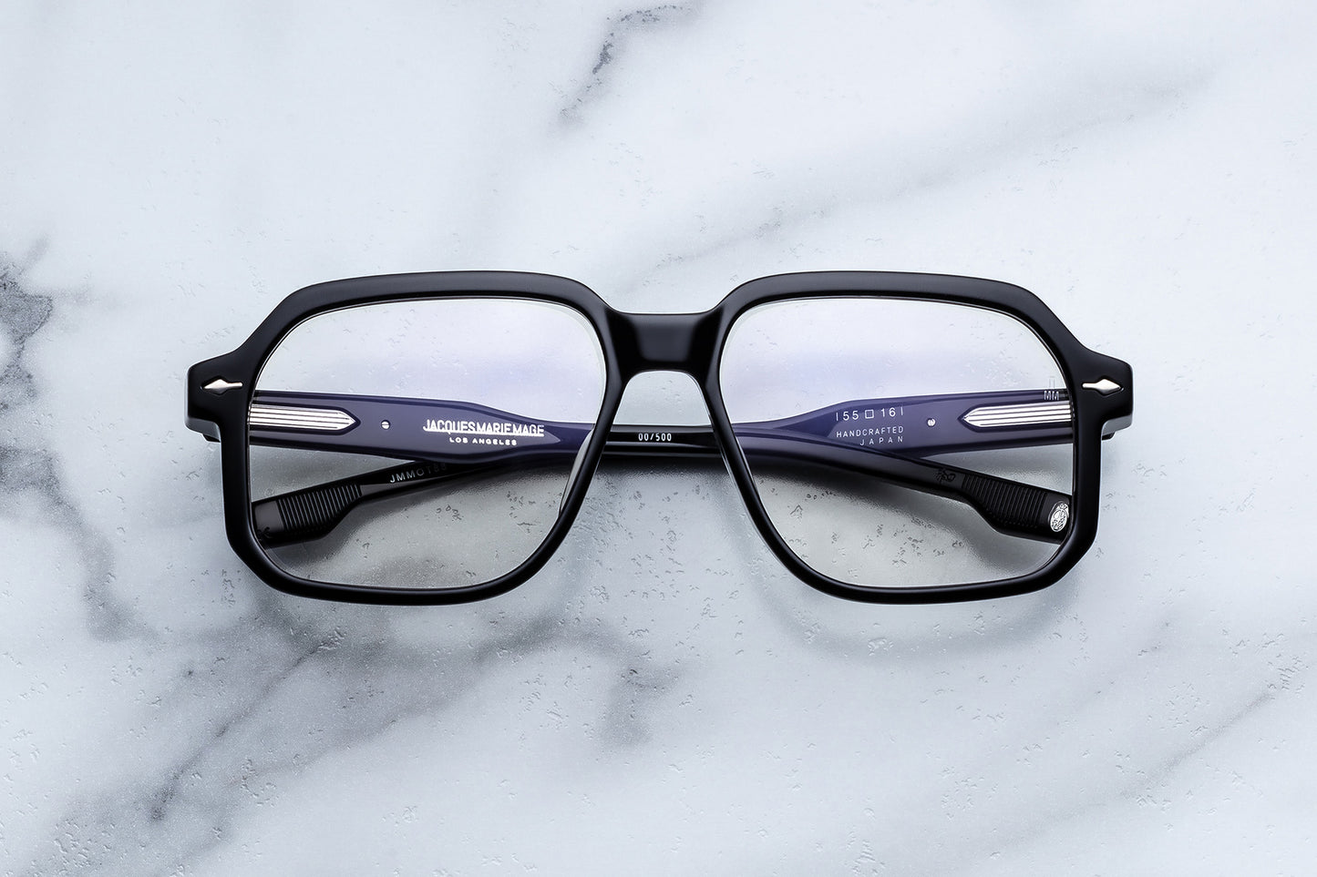 Black eyeglasses on a marble surface