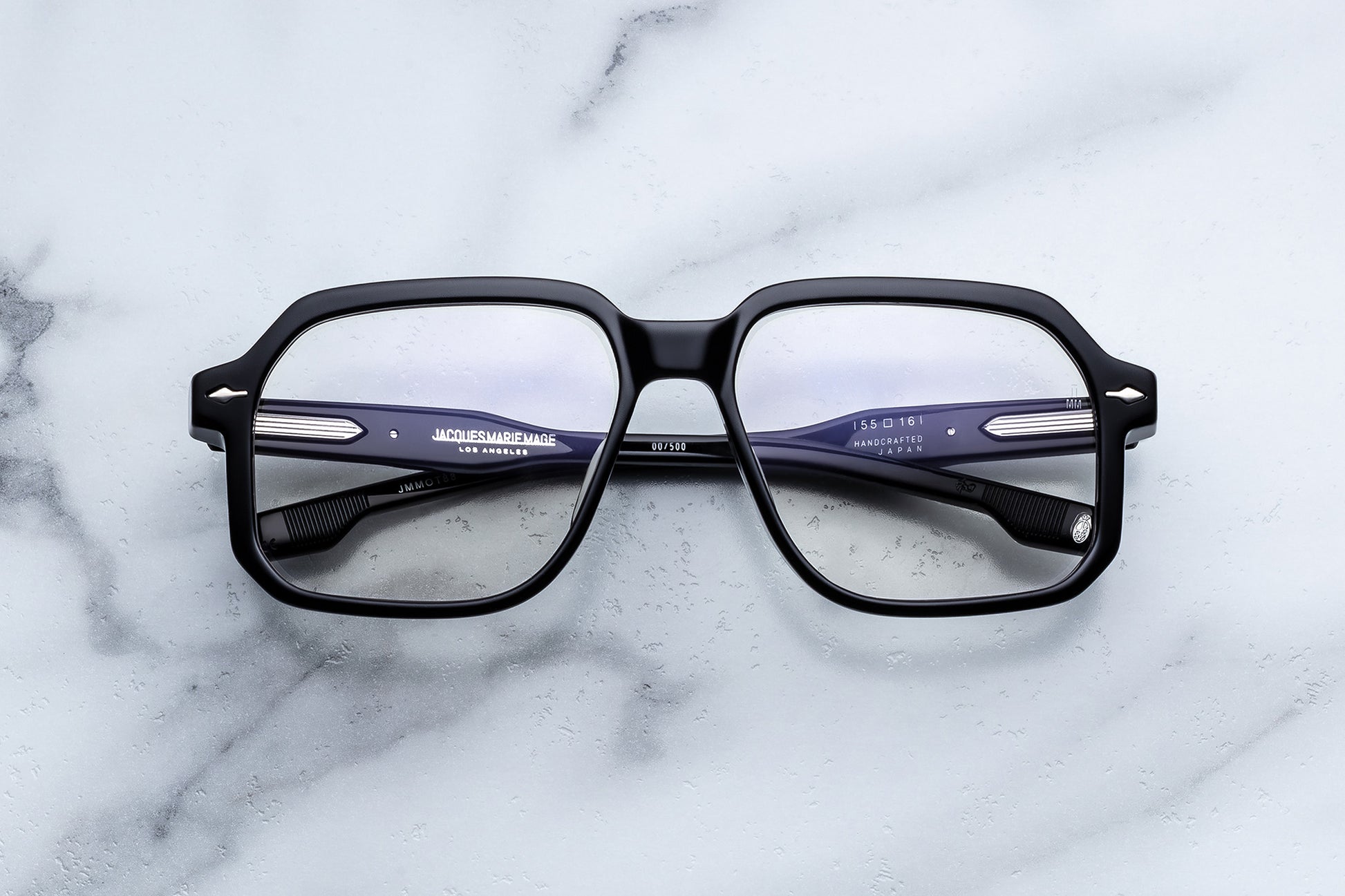 Black eyeglasses on a marble surface