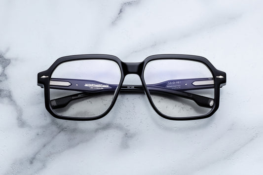 Black eyeglasses on a marble surface