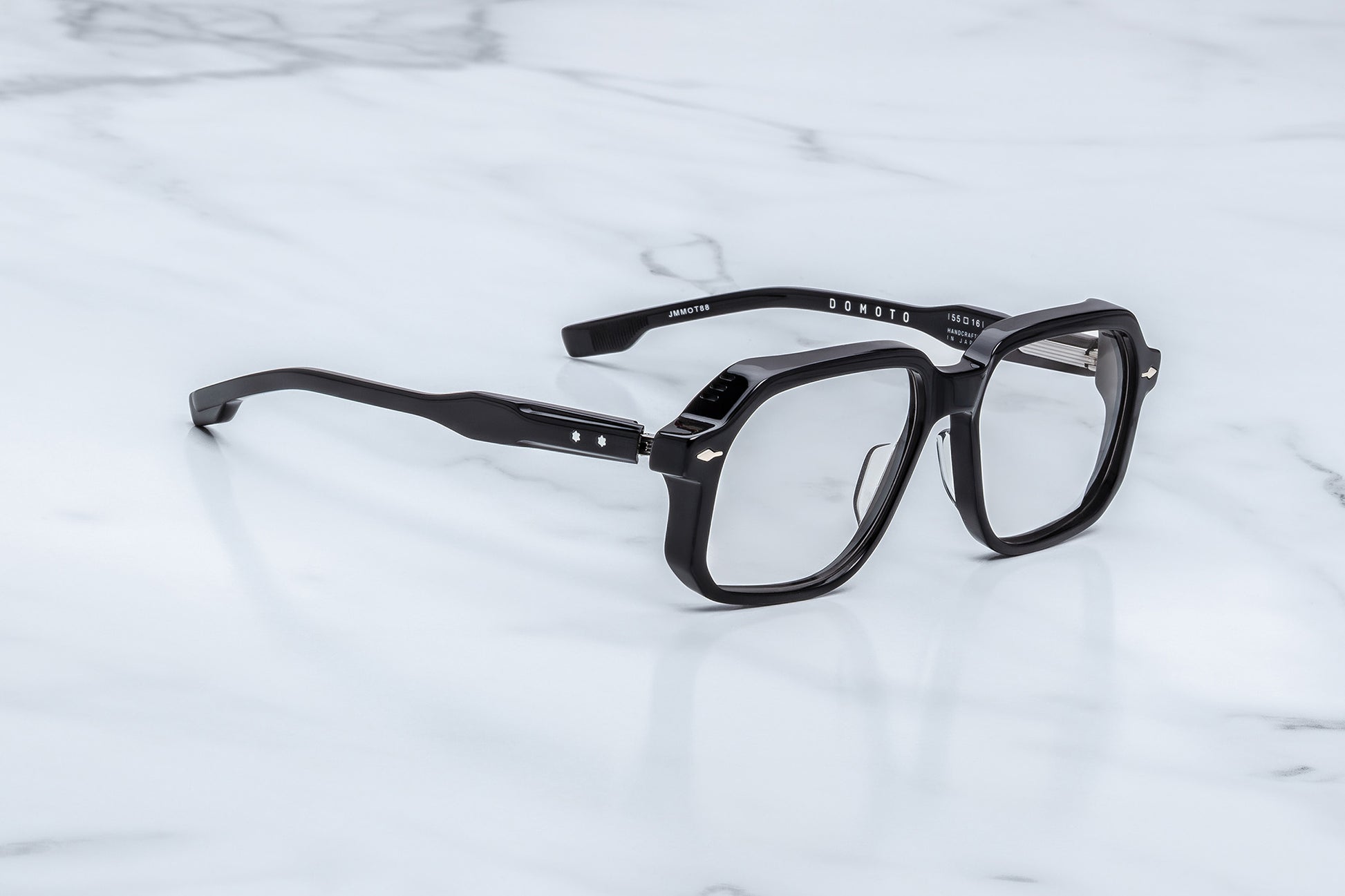 Black eyeglasses on a marble surface