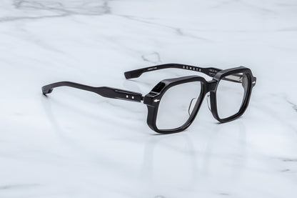 Black eyeglasses on a marble surface