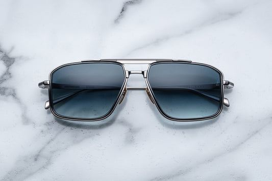 Overhead view of silver aviator sunglasses with blue lenses