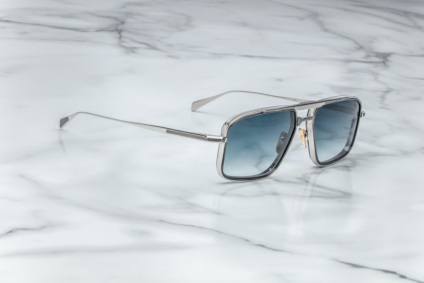 Side view of silver aviator sunglasses with blue lenses
