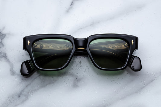 Black sunglasses with reflective lenses on a marble surface