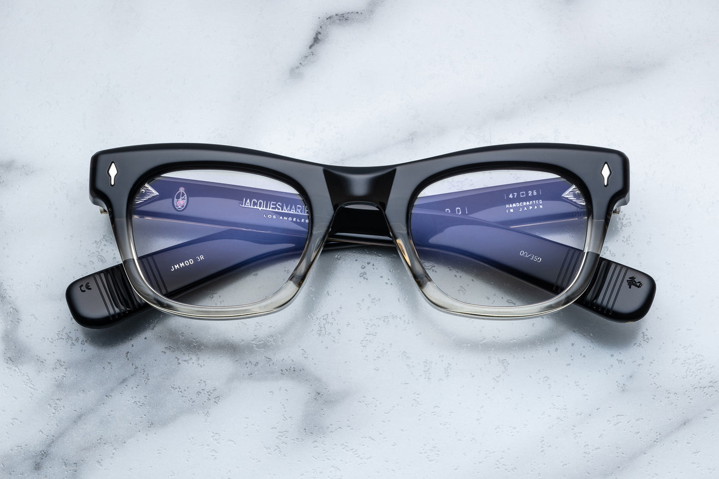 Overhead view of square eyeglasses with a black to clear vertical gradient