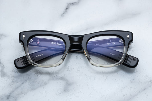 Overhead view of square eyeglasses with a black to clear vertical gradient