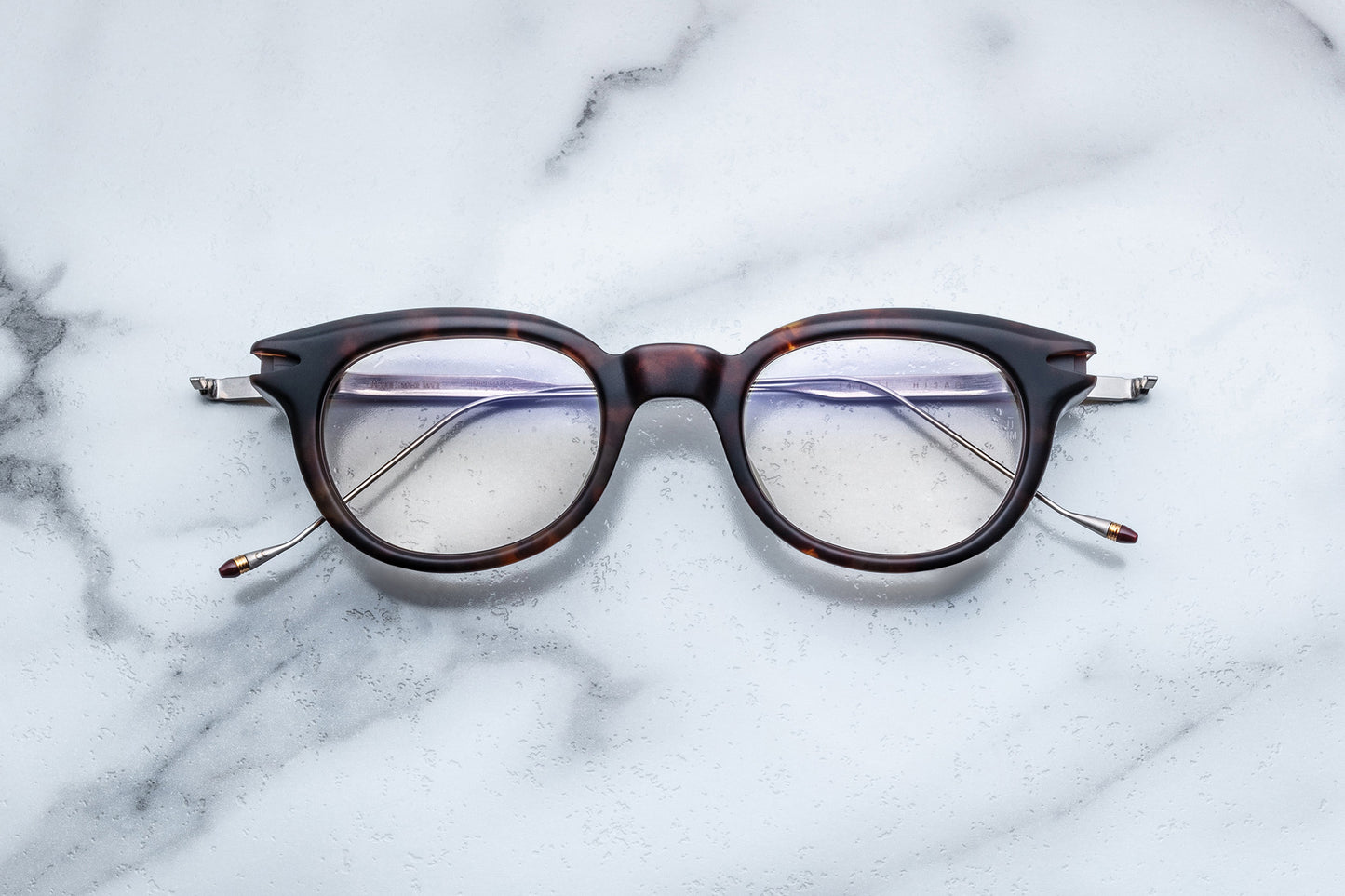 Overhead view of round tortoise-patterned glasses