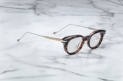 Profile view of round tortoise-patterned glasses