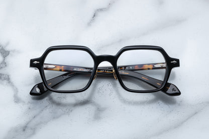 Overhead view of black hexagonal eyeglasses with silver accents