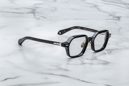 Overhead view of black hexagonal eyeglasses with silver accents