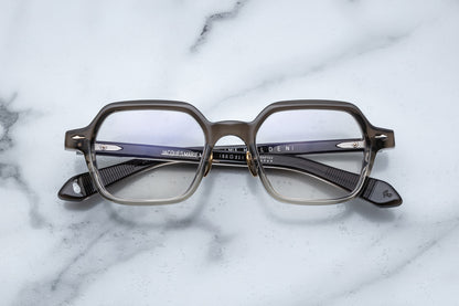Overhead view of hexagonal eyeglasses with silver accents and a vertical brown to clear gradient