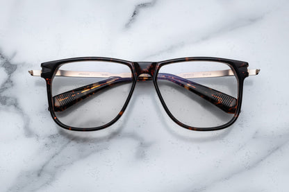 Overhead view of large brown tortoise pattern eyeglasses with silver accents