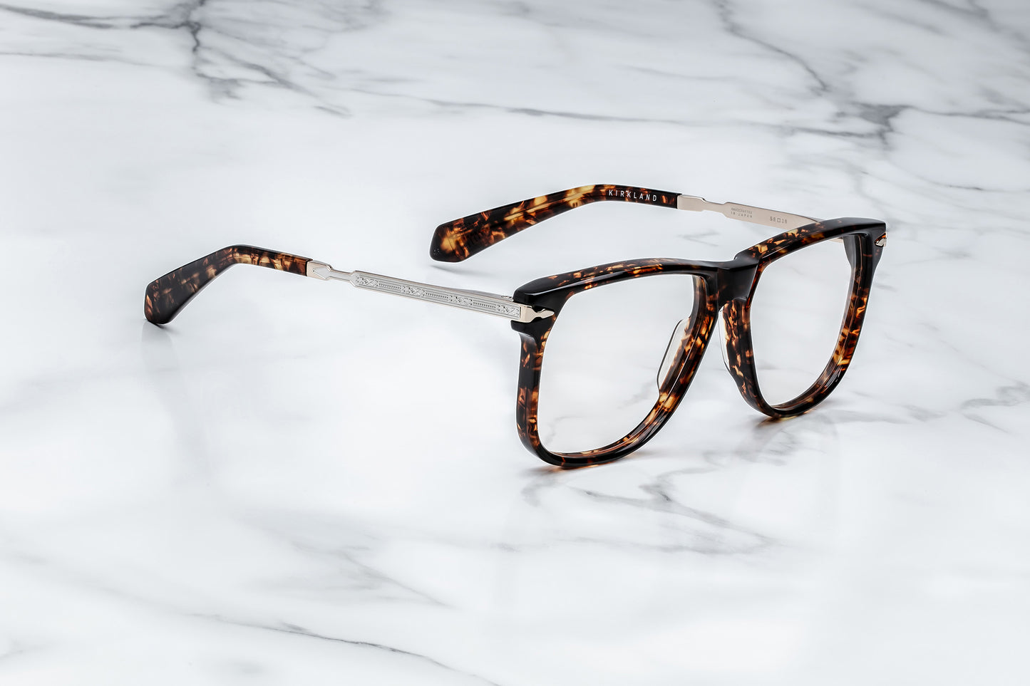 Side view of large brown tortoise pattern eyeglasses with silver accents