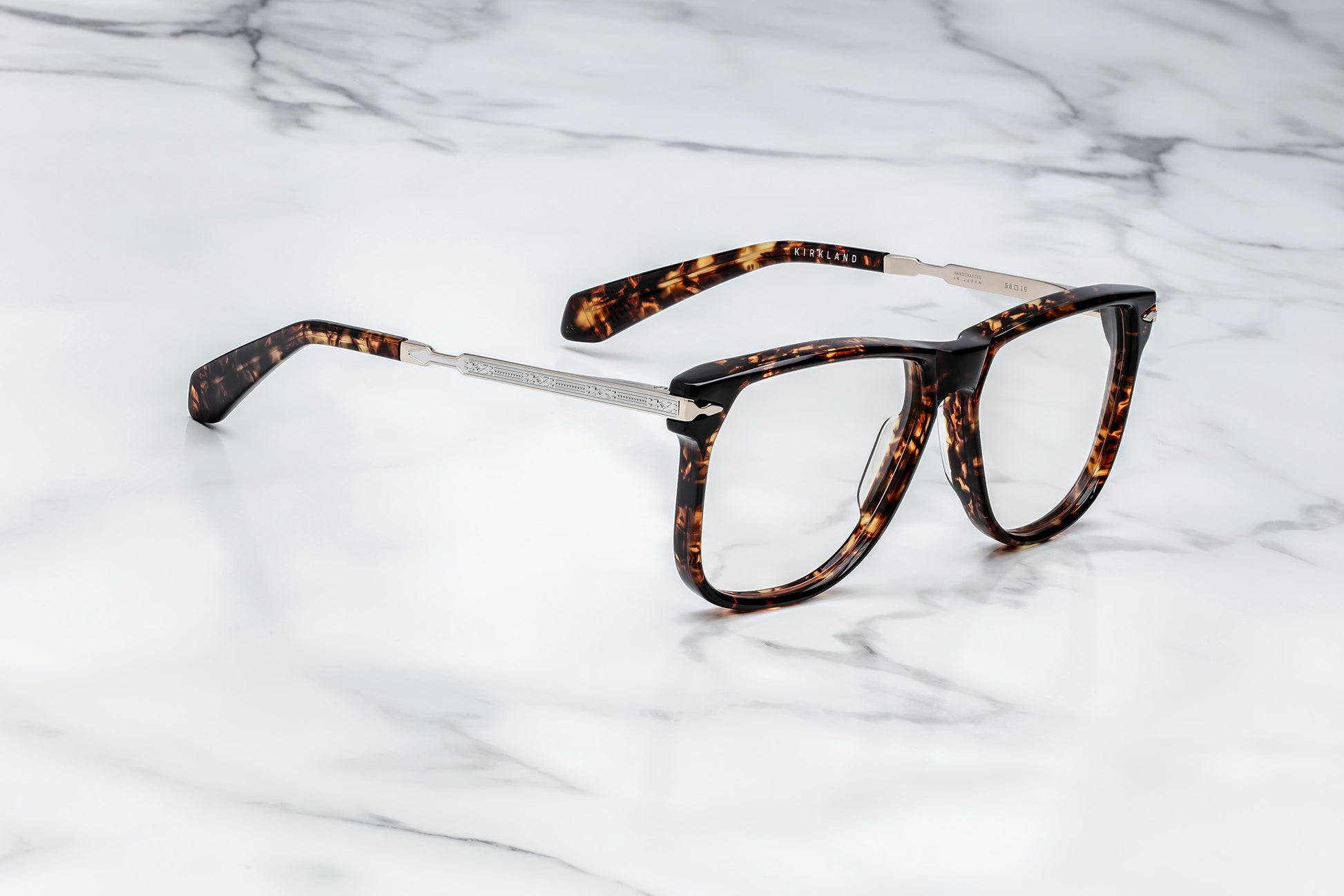 Side view of large brown tortoise pattern eyeglasses with silver accents