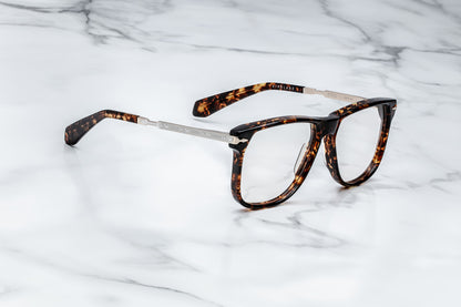 Side view of large brown tortoise pattern eyeglasses with silver accents