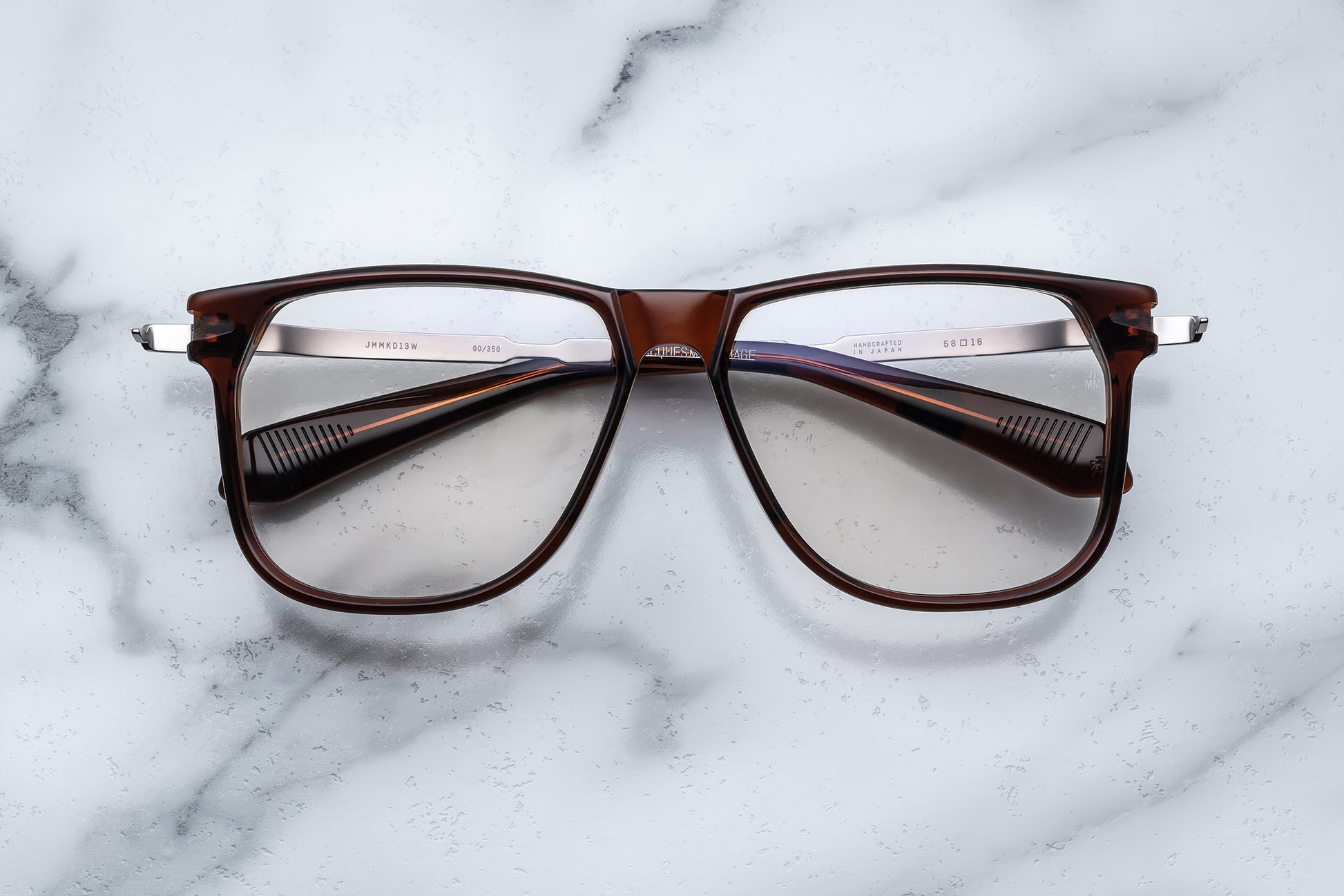 Overhead view of large brown eyeglasses with light gold accents