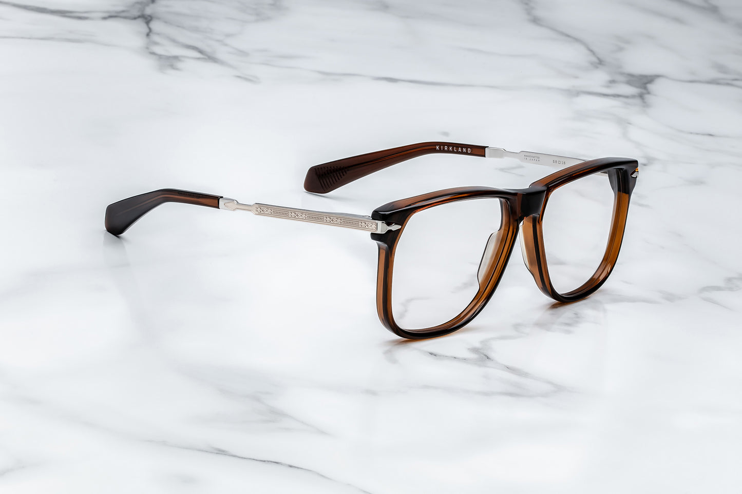 Side view of large brown eyeglasses with light gold accents