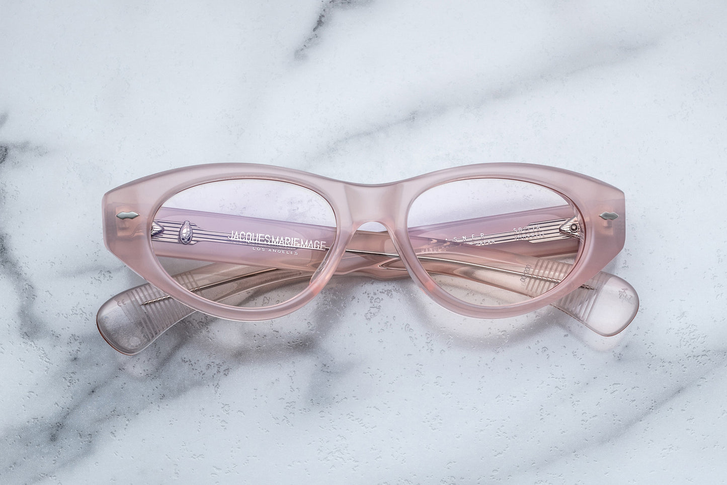 Overhead view of light pink cat-eye classes with clear lenses
