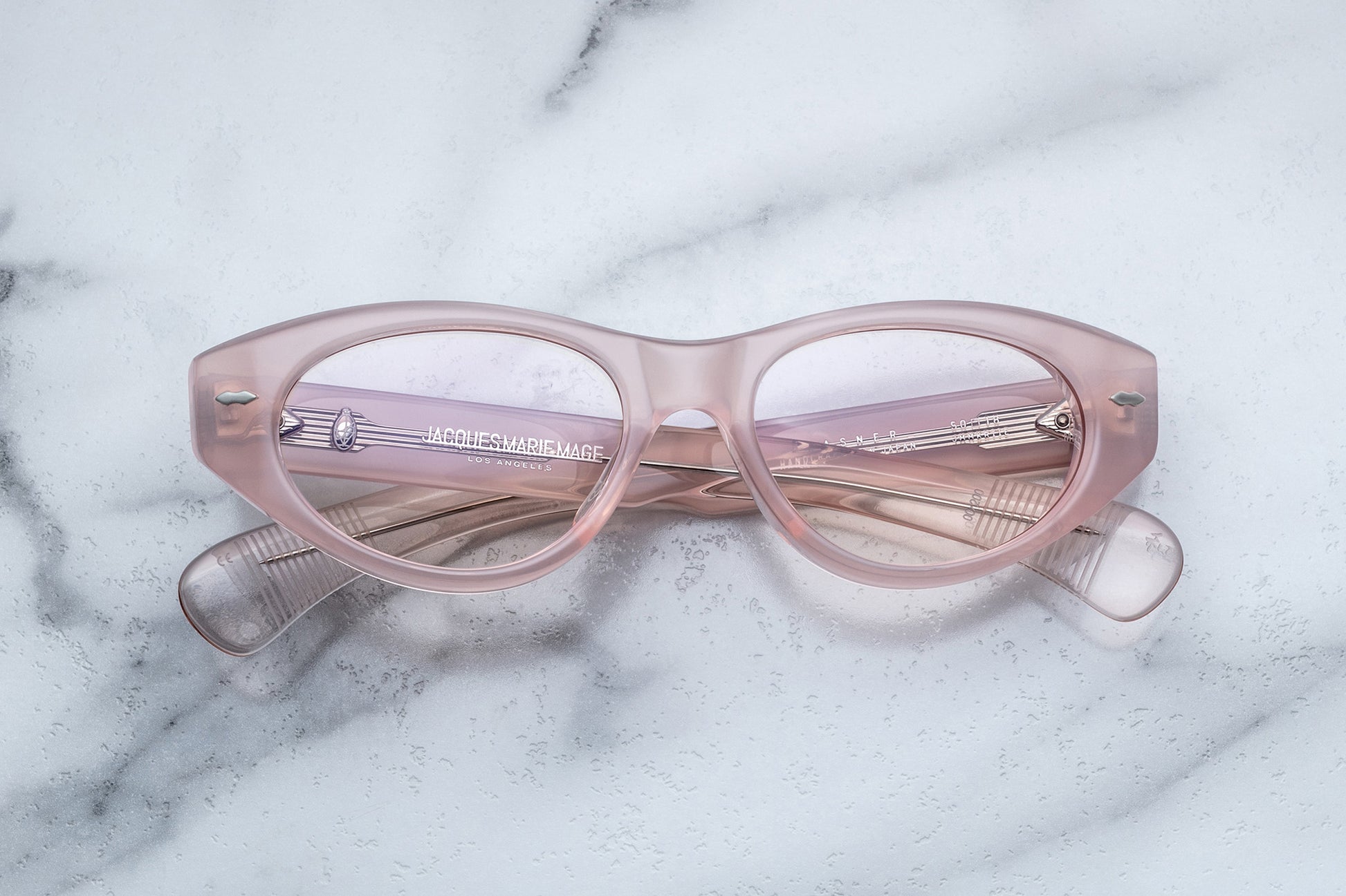 Overhead view of light pink cat-eye classes with clear lenses