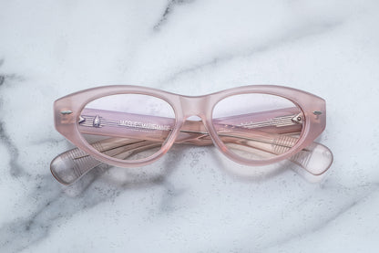 Overhead view of light pink cat-eye classes with clear lenses