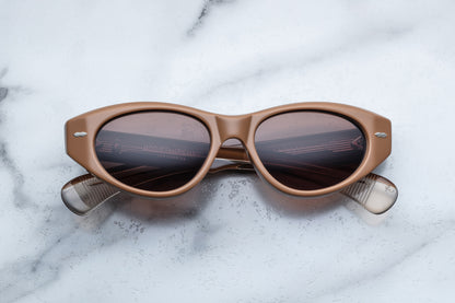 Overhead view of light brown cat eye sunglasses with silver accents