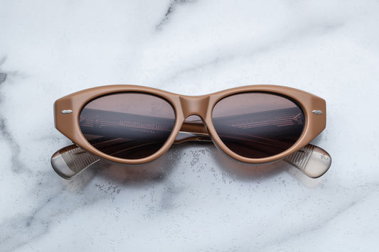 Overhead view of light brown cat eye sunglasses with silver accents