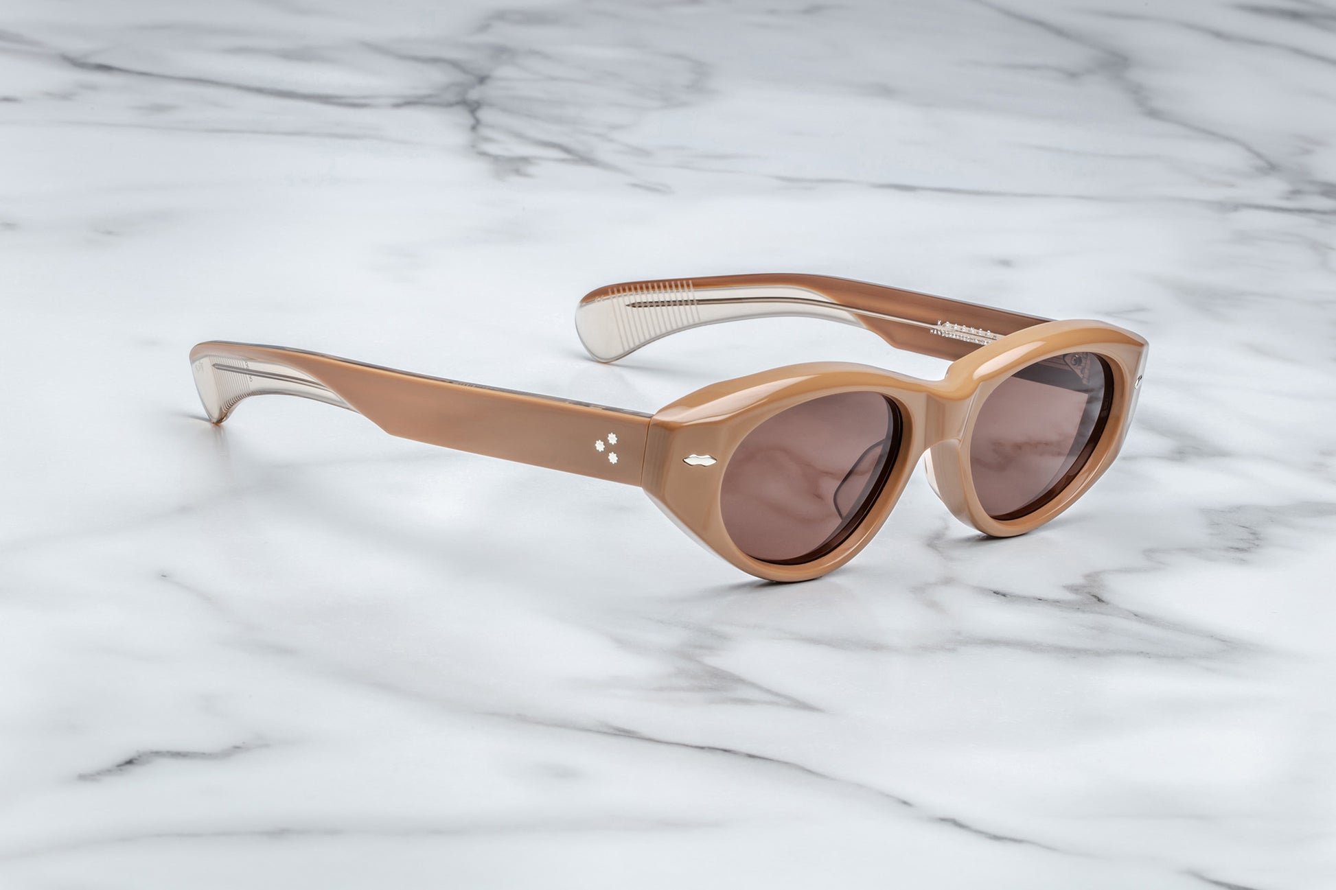 Side view of light brown cat eye sunglasses with silver accents