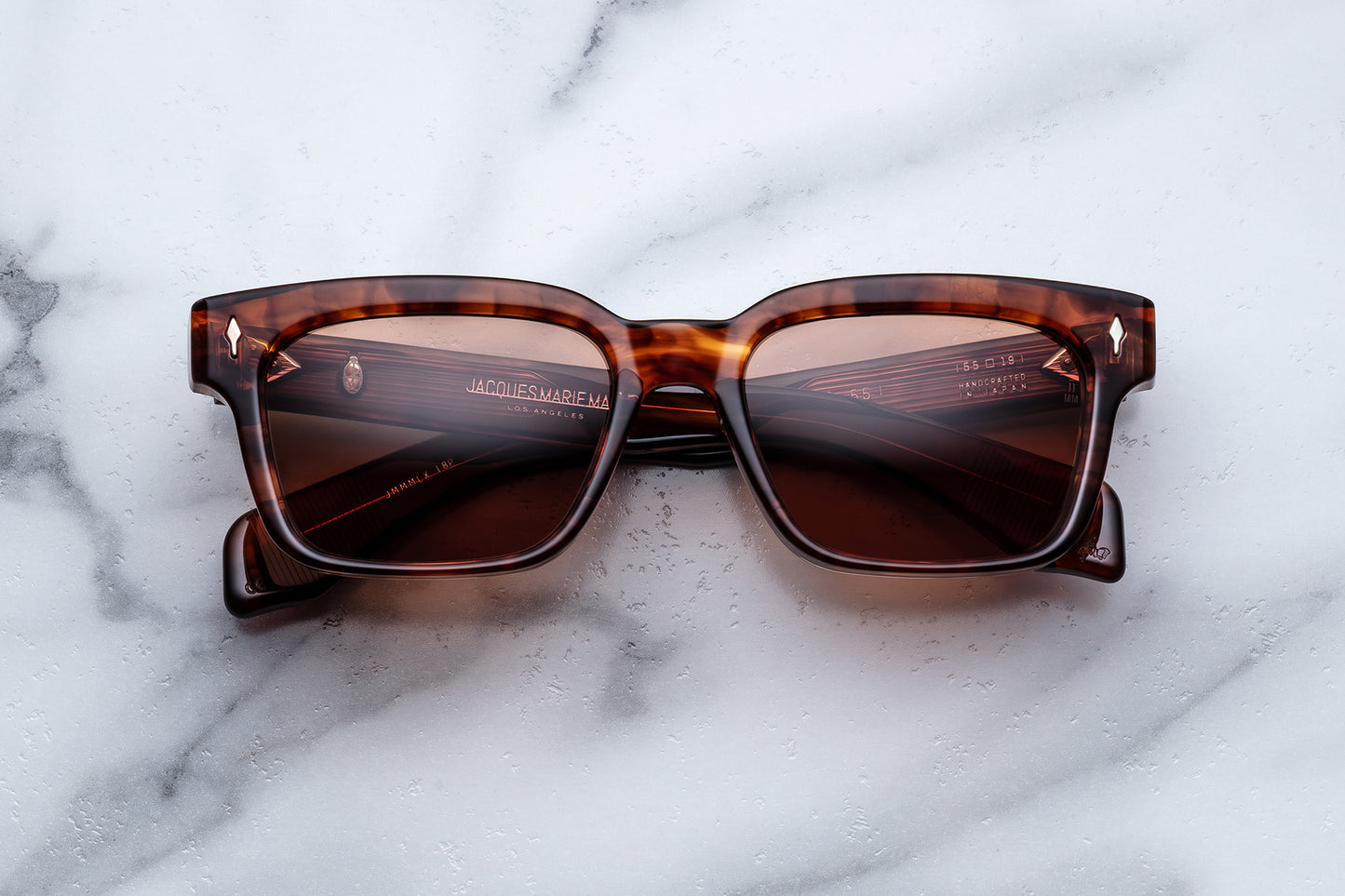 Tortoiseshell sunglasses on a marble surface