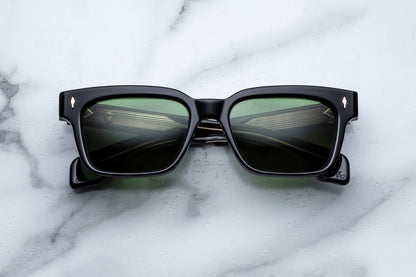 Black sunglasses with reflective lenses on a marble surface
