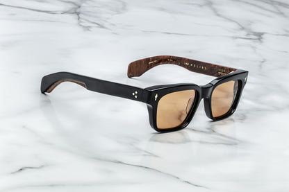 Side view of black rectangular sunglasses with brown orange lenses