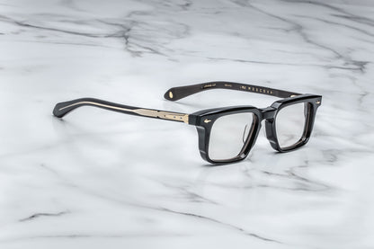 Overhead view of black rectangular eyeglasses with gold accents