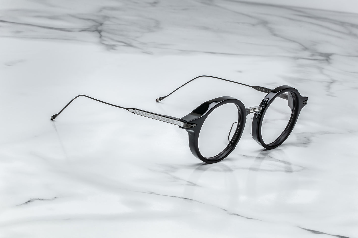 Side view of black round eyeglasses with silver temples