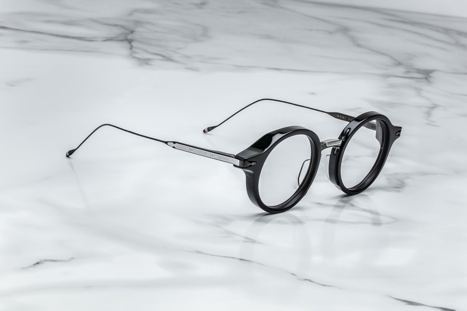 Side view of black round eyeglasses with silver temples