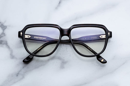 Black eyeglasses on a marble surface