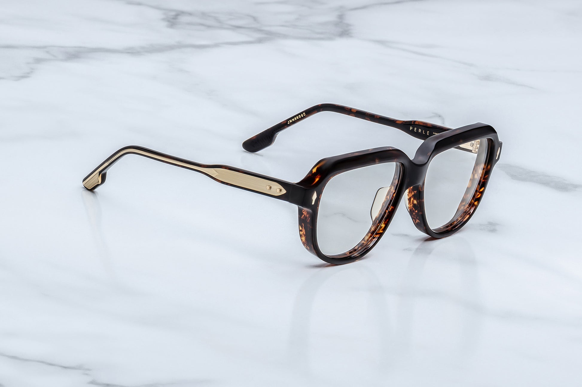 Tortoiseshell eyeglasses on a marble surface
