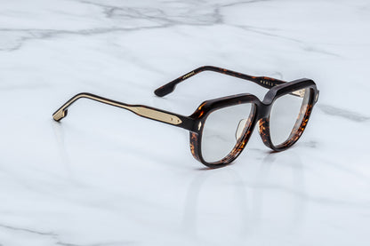 Tortoiseshell eyeglasses on a marble surface