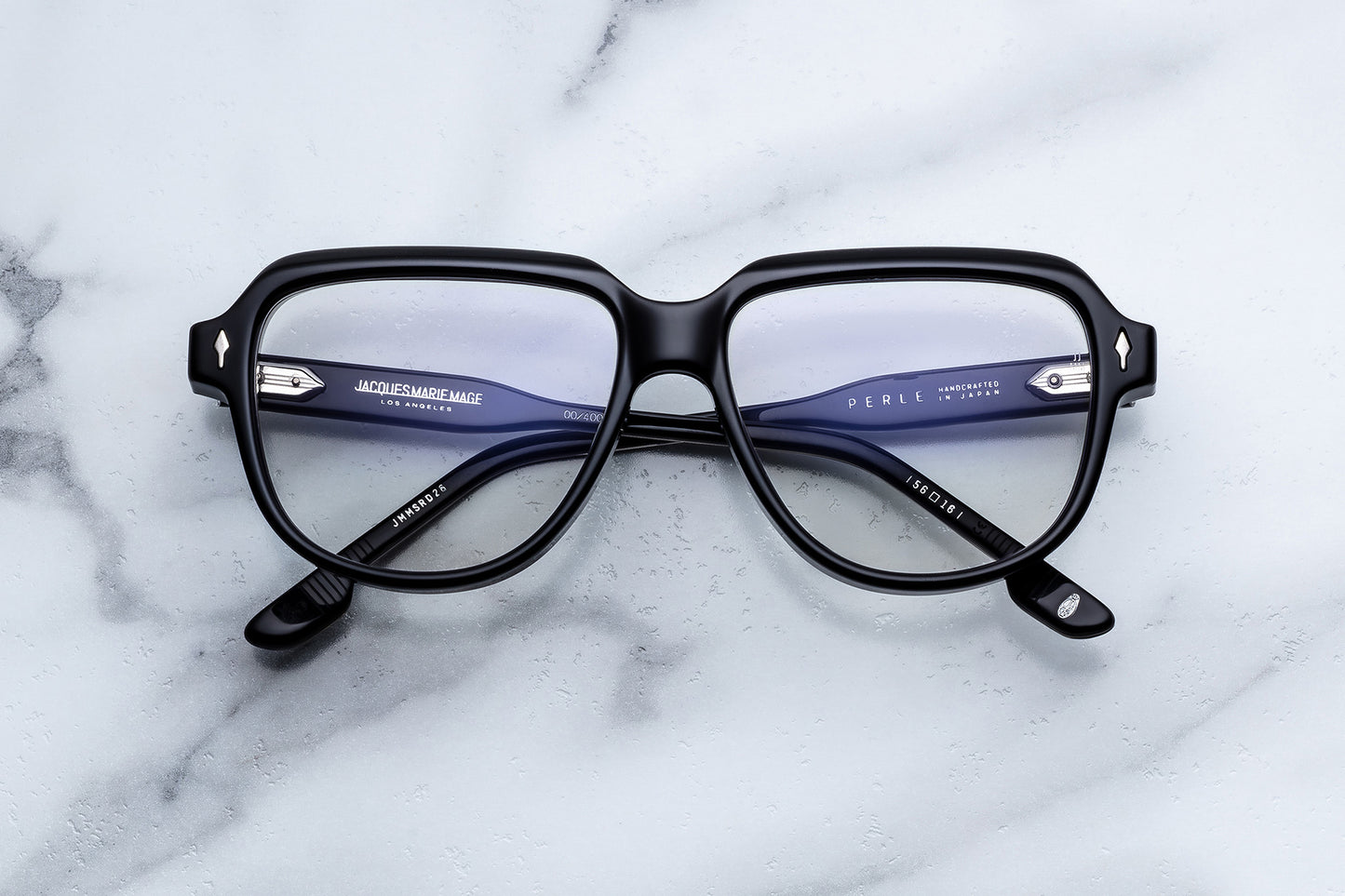 Black eyeglasses on a marble surface