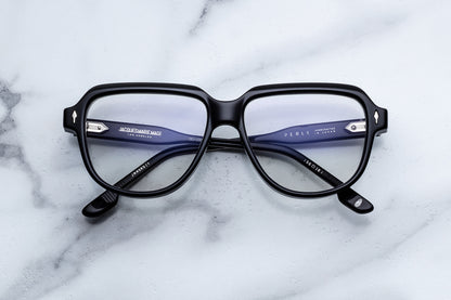Black eyeglasses on a marble surface