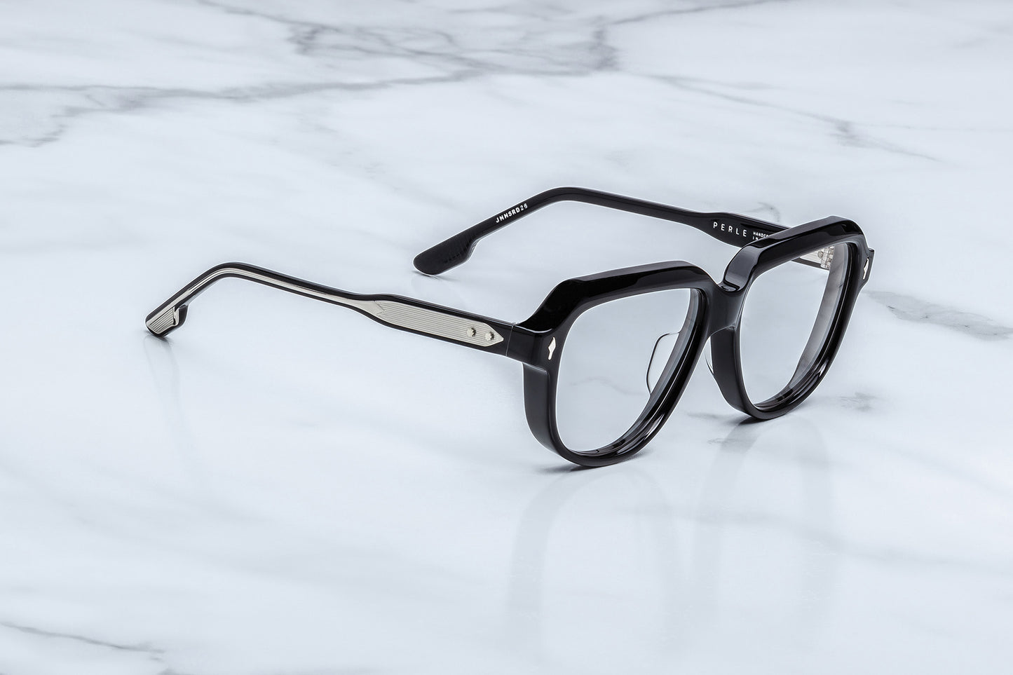 Black eyeglasses on a marble surface