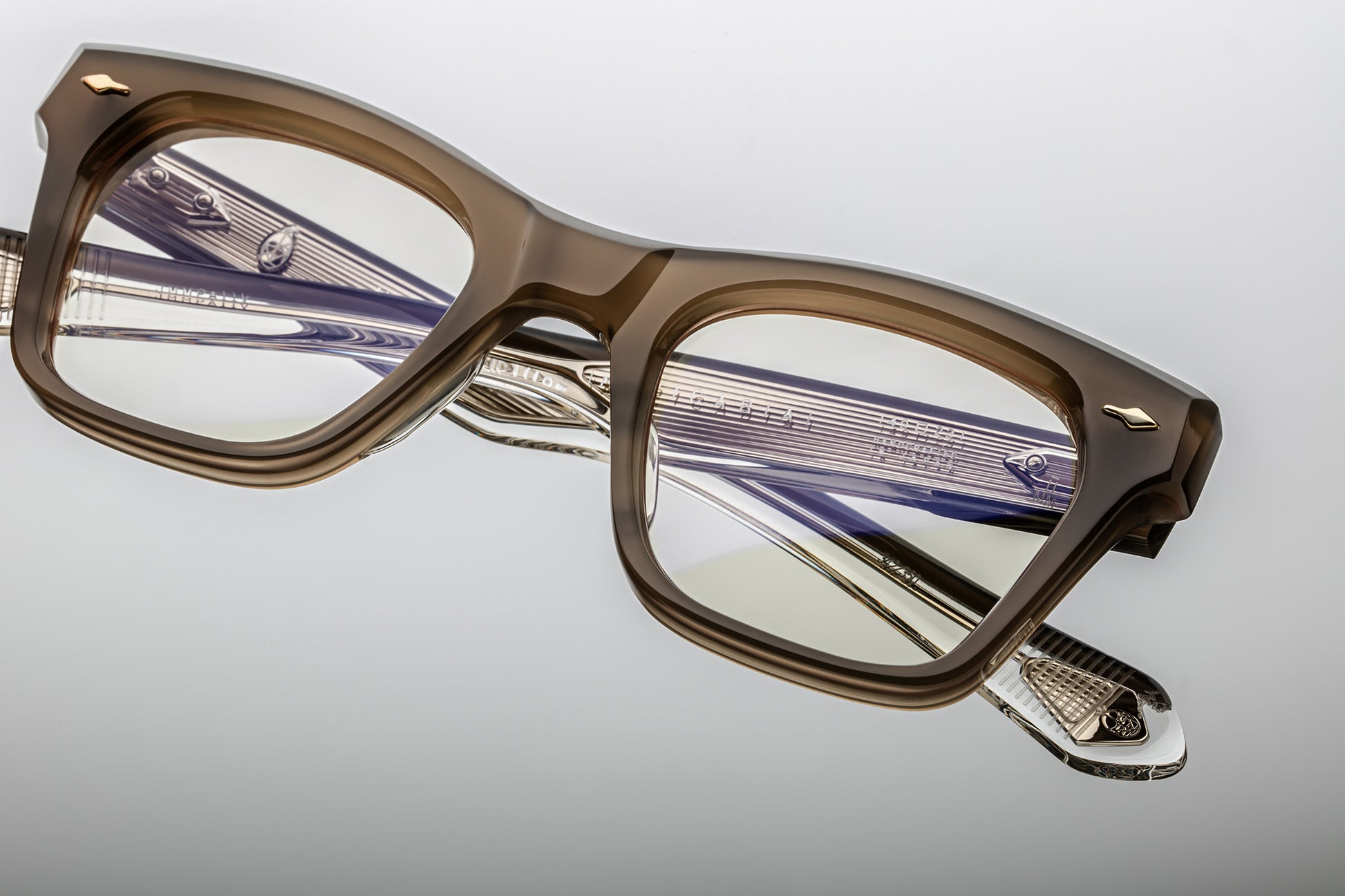 Rectangular eyeglasses with brown grey frames and silver accents