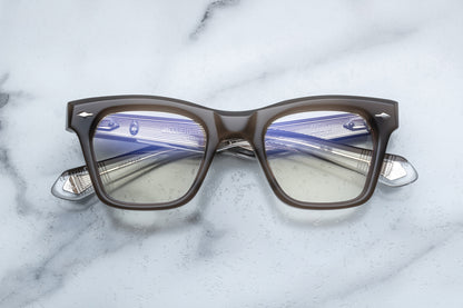 Overhead view of rectangular eyeglasses with brown grey frames and silver accents