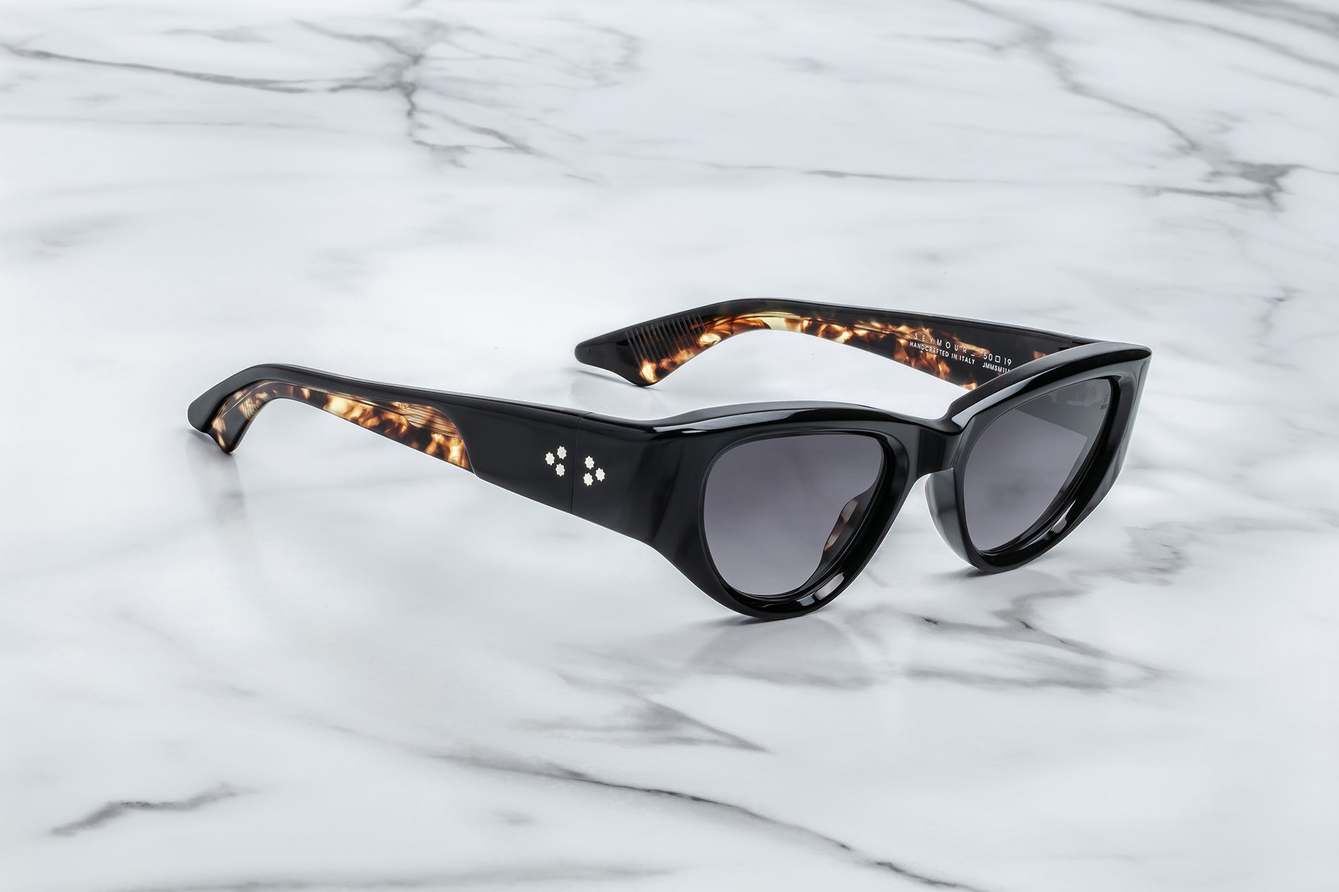 Side view of black cat eye sunglasses with grey lenses