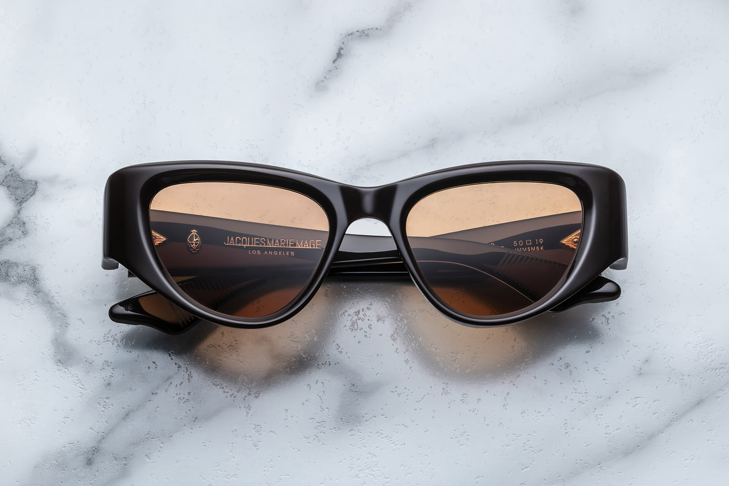 Overhead view of brown cat eye sunglasses with orange lenses