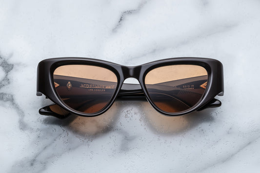 Overhead view of brown cat eye sunglasses with orange lenses