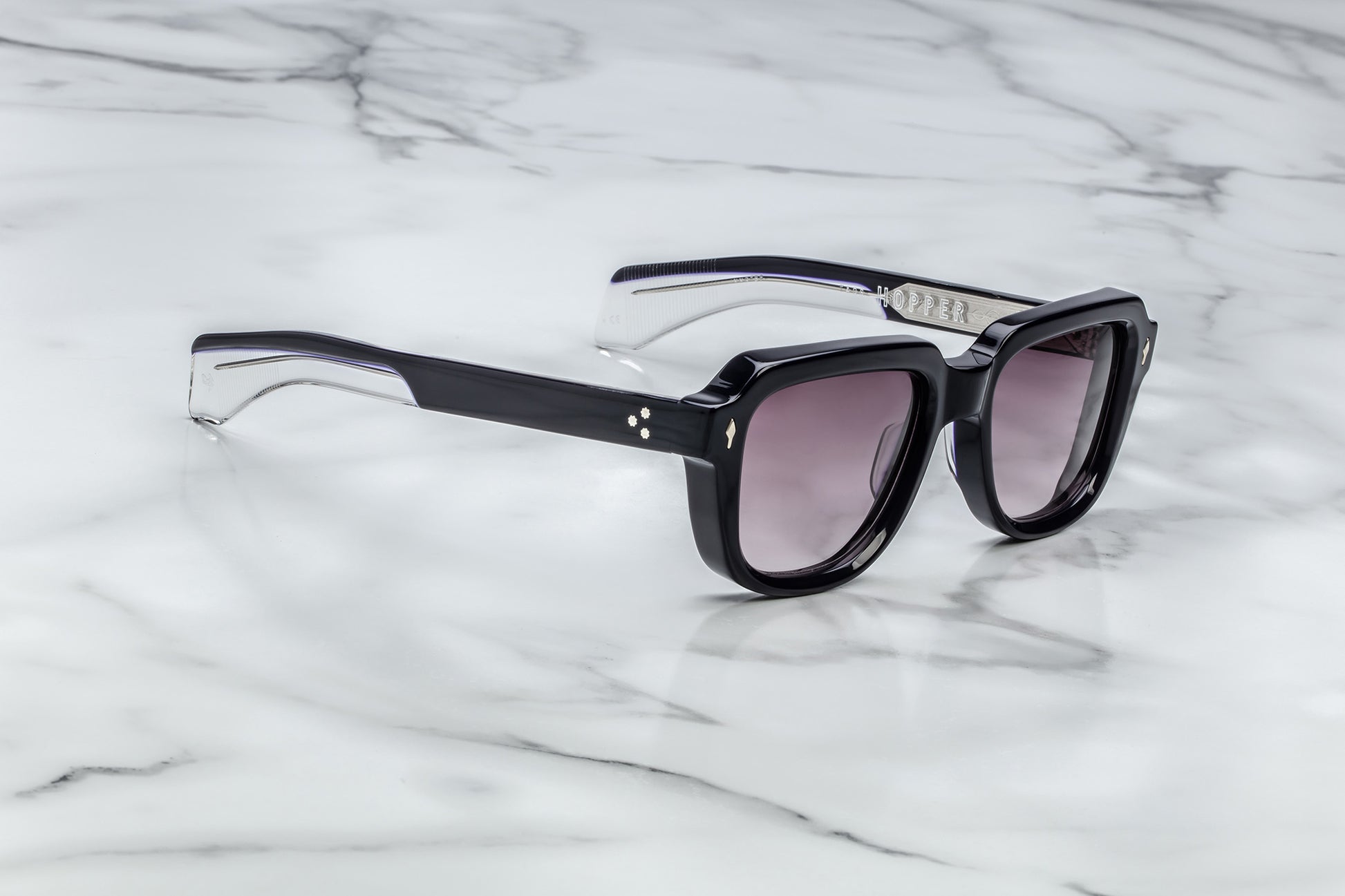 Side view of black sunglasses with purple lenses
