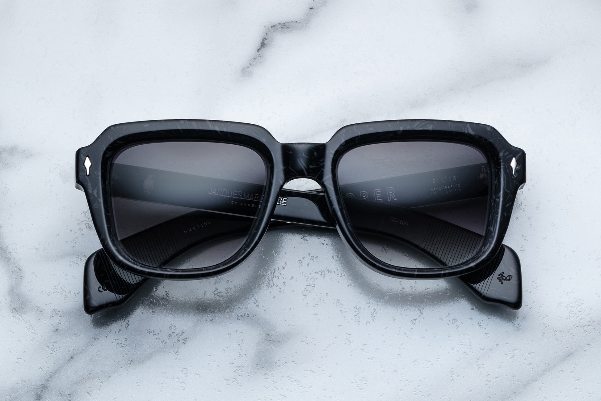 Overhead view of black sunglasses with black lenses