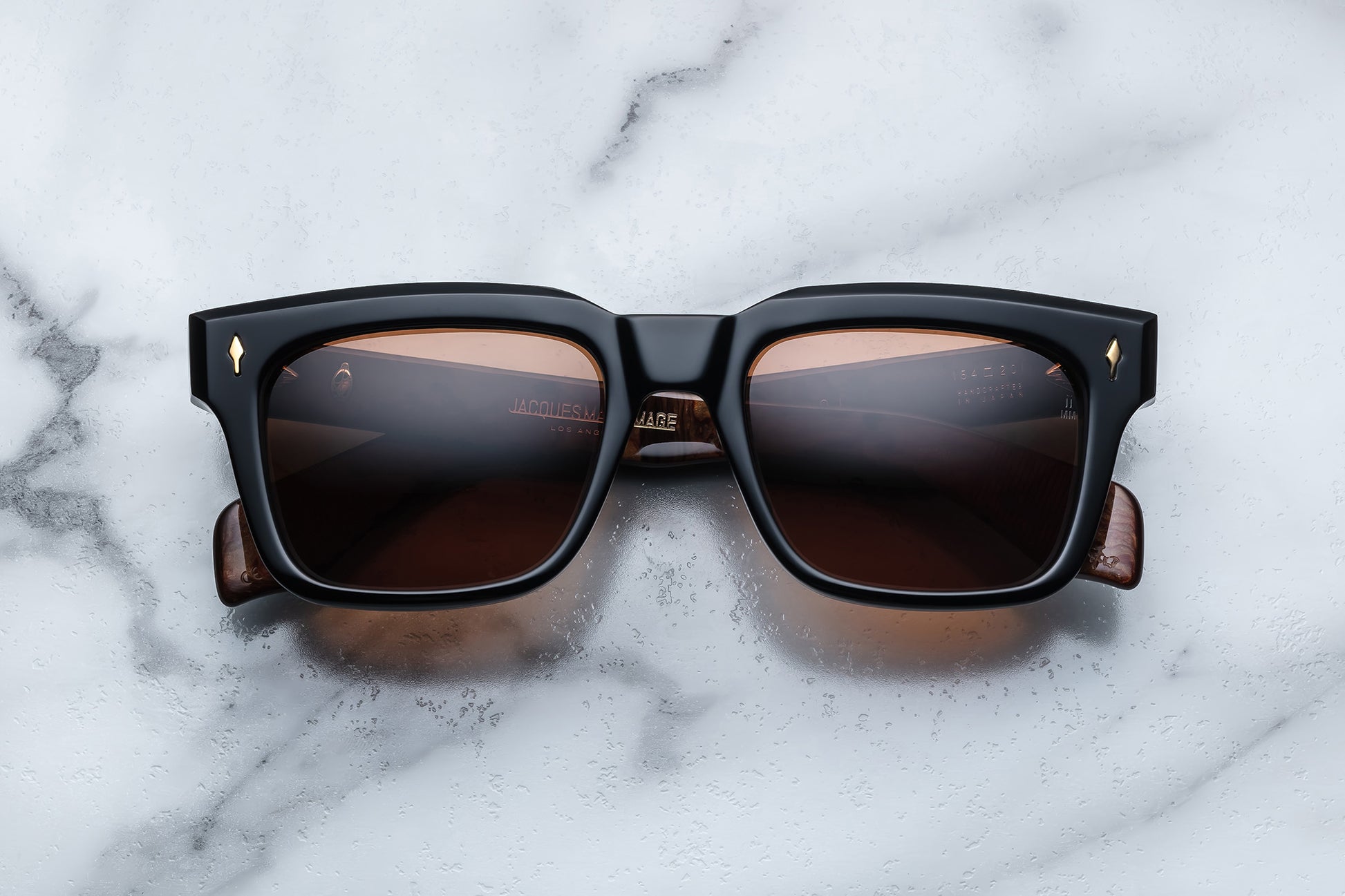 Overhead view of black rectangular sunglasses with orange lenses
