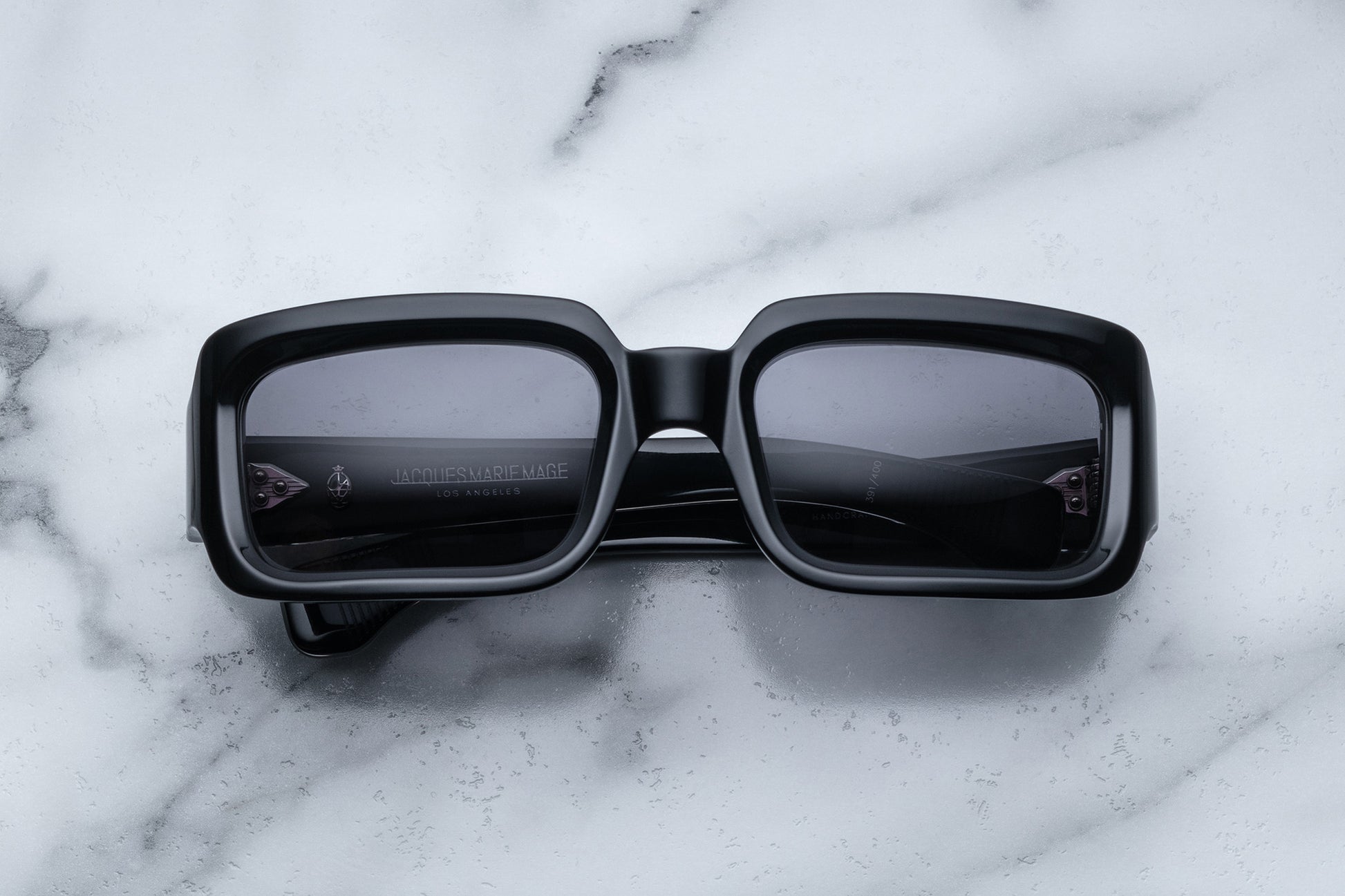 Overhead view of black rectangular sunglasses with black lenses